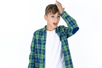 Caucasian teen boy surprised with hand on head for mistake, remember error. Forgot, bad memory...