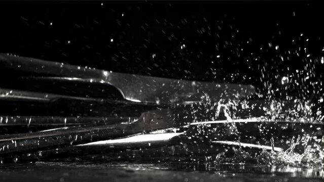 The knife falls on the black table. Filmed on a high-speed camera at 1000 fps. High quality FullHD footage