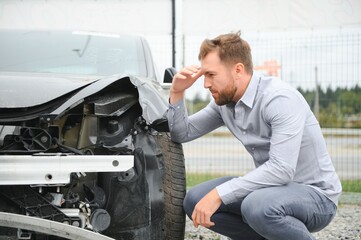Car accident. Man after car accident. Man regrets damage caused during car wreck