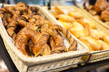Delicious bavarian pretzel in baskets in bakery