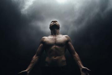 portrait of a man looking up to dark dramatic sky