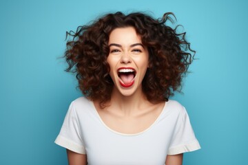 Happy successful young woman, female face beauty portrait, joyful hands up, curly hair, happiness