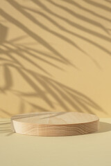 Cylindrical wooden scene with the shadow of palm leaves on beige background. Premium empty podium...
