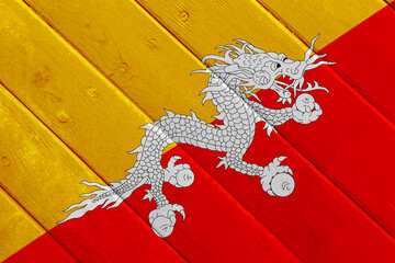 Flag of Kingdom of Bhutan on a textured background. Concept collage.