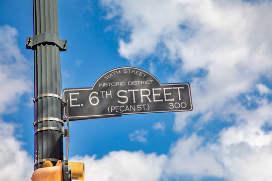 street sign 6th street - pecan street -  in Austin, Texas, historic district, USA