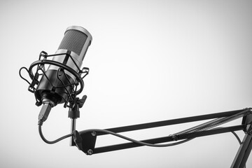 Studio microphone on the mic stand with gray background. Copy space.