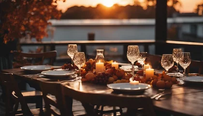 Tuinposter Autumn outdoor dinner table on patio, sunset © abu