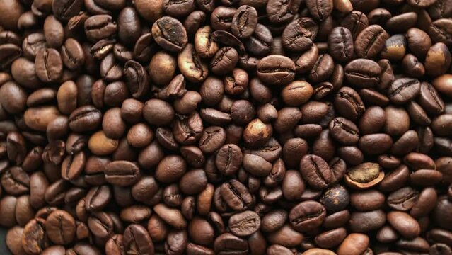 Close up slowly rotating coffee beans background