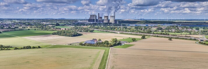 Panoramic picture of a coal-fired power station with smoking chimneys