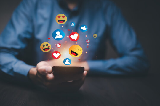 Social media and online digital concept, people online using social media with illustration hologram of emojis showing and floating, social distancing, work from home concept.