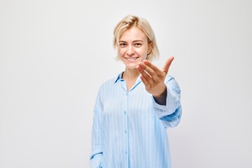 Portrait of confident girl chooses you points finger at camera isolated on white studio background. Welcome gesture, join our team concept.