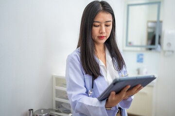 Portrait of Mature Female Doctor Wearing white Coat with Stethoscope Standing in Hospital Corridor. Concept Of Medical Technology and Healthcare Business.