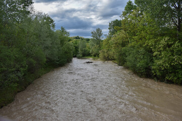 Flooded river valley with muddy waters steaming Bizdidel river, left tributary of Ialomita River,...