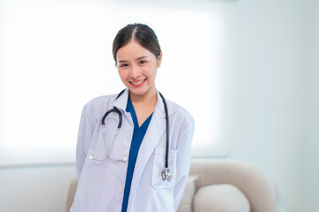 Fototapeta premium Portrait of Mature Female Doctor Wearing white Coat with Stethoscope Standing in Hospital Corridor. Concept Of Medical Technology and Healthcare Business.