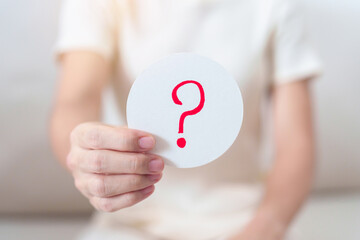 Woman show Questions Mark ( ? ) on paper. FAQ, frequency asked questions, Answer, Q and A,...