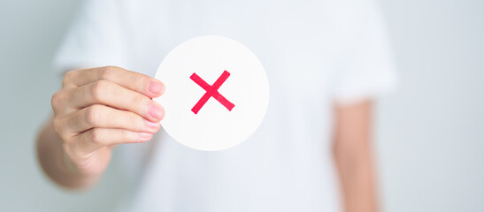 Woman show Wrong symbol paper. True and false, accept and rejected, evaluation, Vote, Poll, Yes or...