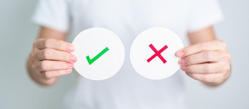 Woman show Wrong and Right symbol paper. True and false, accept and rejected, evaluation, Vote, Poll, Yes or No and Survey concepts