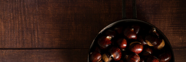 Close up view of chestnuts on table, space for text. Agricultural harvest concept. Healthy, seasonal food
