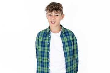 Caucasian teen boy winking looking at the camera with sexy expression, cheerful and happy face.