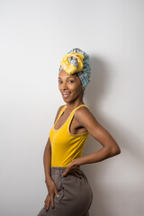Portrait of beautiful happy young casual black woman wearing a headwrap. - 673754392