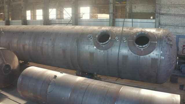 Huge pipes at a pipe factory. Plant for the production of large diameter pipes. Reservoir for pumping oil and gas.