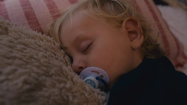 Close up of toddler sleeping with a pacifier. Shot with RED helium camera in 8K. 