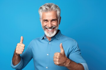 Happy Man Gives Thumbs Up On Vibrant Blue Backdrop