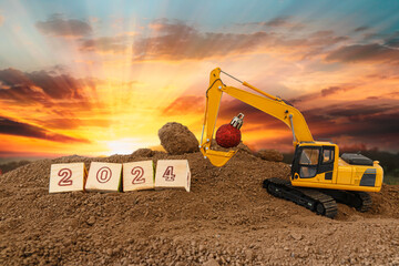 Concept Happy new year 2024,crawler excavator in construction site .on sunrise backgrounds