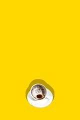 Empty cup with coffee grounds isolated on yellow background. Fortune telling. Contemporary art collage. Concept of popular drink, abstract art, creativity, color, taste. Poster. Copy space for ad