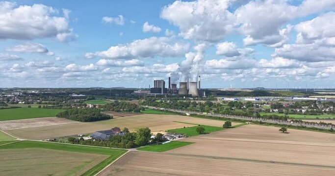Drone time lapse of a coal-fired power station with smoking chimneys