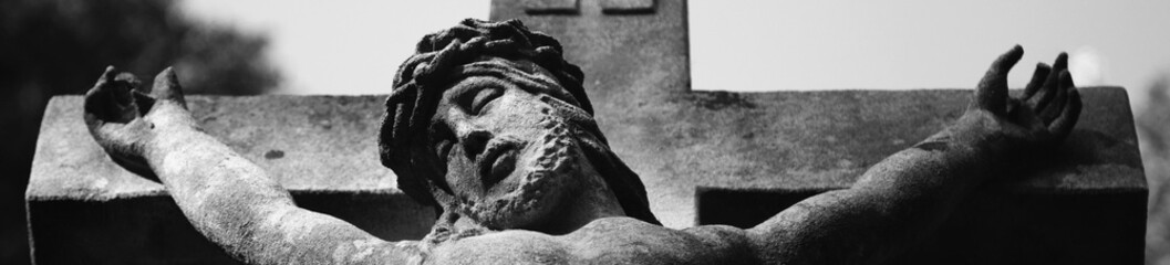 Suffering and death of Jesus Christ. View from the bottom of the ancient statue. Black and white image.