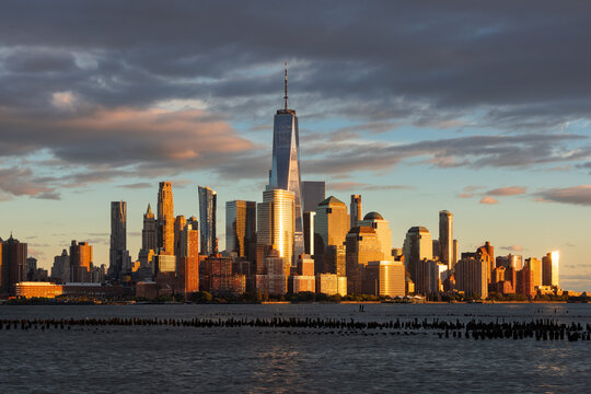 Dramatic New York City skyline at sunset from the Hudson River with World Trade Center skyscrapers. Financial District of Lower Manhattan.