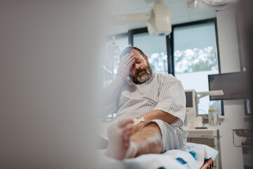 Overweight patient in hospital gown waiting for medical examination, test results in hospital,...