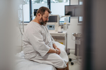 Overweight patient in hospital gown waiting for medical examination, test results in hospital,...