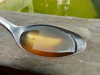 closeup of honey in a spoon.