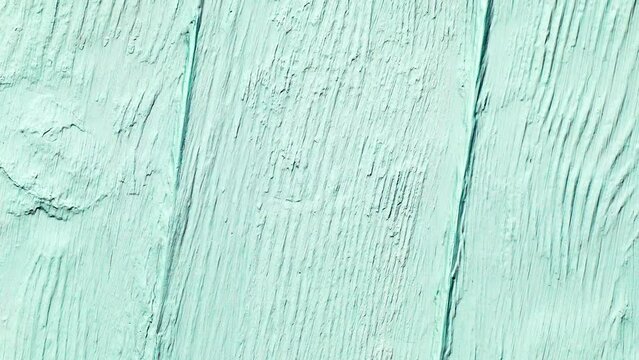 Table top background of wood rude painted with tiffany color paint boards, rotating, turning, close-up macro
