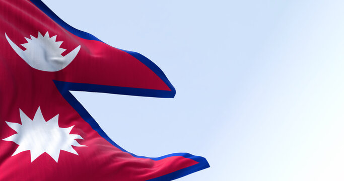 Close-up of Nepal National flag waving in the wind on a clear day