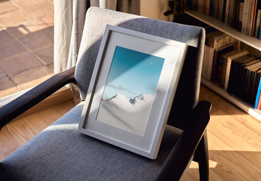 Mockup of customizable vertical wooden picture frame on chair