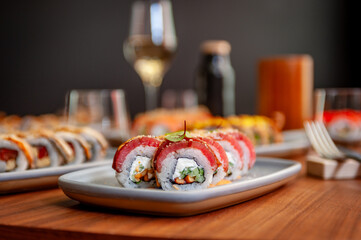 Sushi roll with tuna, cream cheese, cucumber and curry sauce on a plate