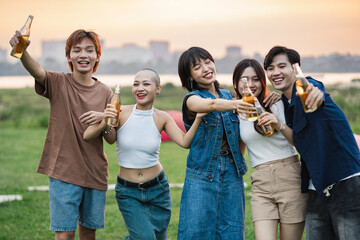Image of group of friends celebrating and drinking beer together - obrazy, fototapety, plakaty