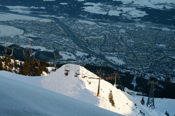 A ski lift glides over the snow-covered mountain, carrying skiers upwards to the breathtaking views and exhilarating slopes.