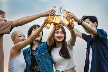 Image of group of friends celebrating and drinking beer together - obrazy, fototapety, plakaty