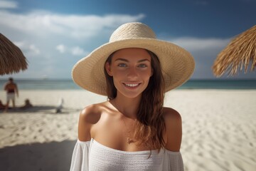 Portrait of a happy lady with beach hat at sand beach. Summer tropical vacation concept.