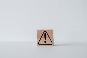 Notification icon on wooden cube over white background concept for warning,hazard and...