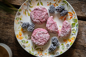 Baked blackberry Syrniki with blackberry sauce. Side view. 