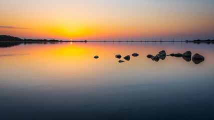 A rising sun over the lagoon Stagno di Notteri on Sardinia island.