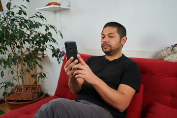 Guy on Couch Having a Video Chat Session