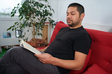 Serene Man Reading Book on Couch