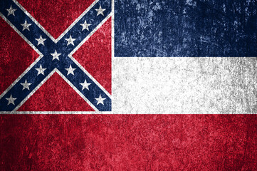 Close-up of the grunge Mississippi State flag. Dirty Mississippi State flag on a metal surface.