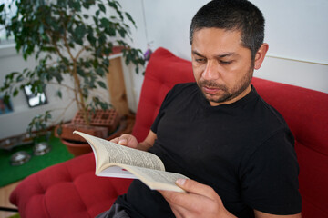 Cozy Evening: Man Reading on Sofa